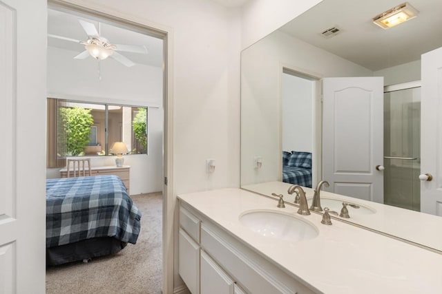 bathroom featuring ceiling fan, walk in shower, and vanity