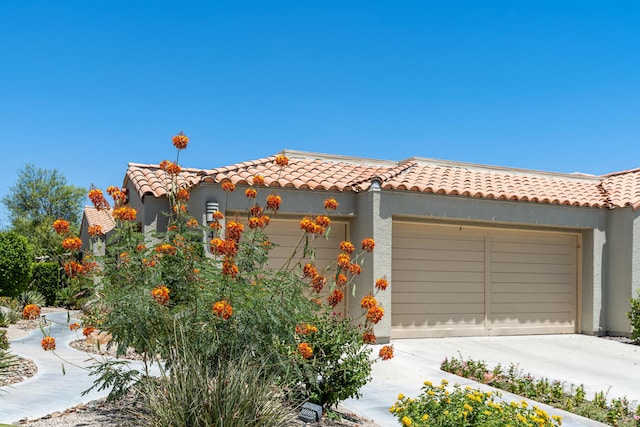 mediterranean / spanish house with a garage