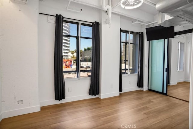 unfurnished room featuring hardwood / wood-style flooring