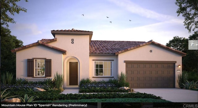 mediterranean / spanish-style home featuring concrete driveway, a tile roof, an attached garage, and stucco siding