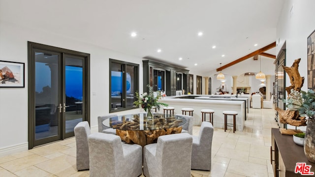 dining area featuring lofted ceiling with beams