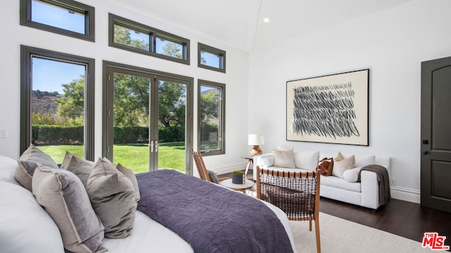 bedroom with high vaulted ceiling, access to outside, and dark wood-type flooring