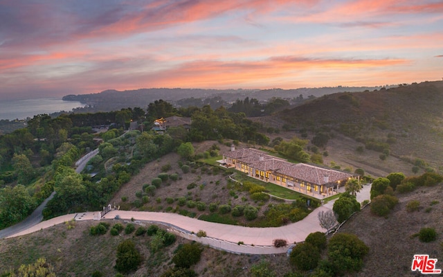 aerial view at dusk with a water view