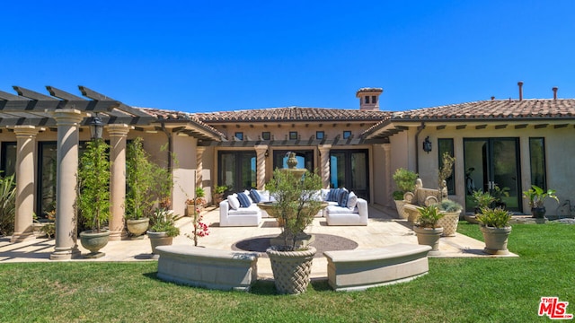 rear view of house with a lawn, a pergola, and a patio area