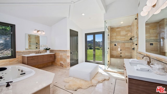 bathroom with high vaulted ceiling, vanity, tile patterned flooring, separate shower and tub, and french doors