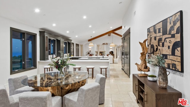 dining area with lofted ceiling with beams and ornate columns