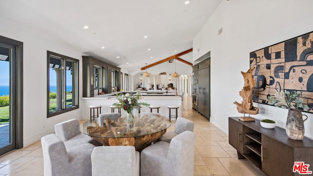 dining room featuring vaulted ceiling with beams