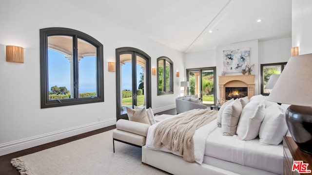 bedroom with hardwood / wood-style flooring and vaulted ceiling