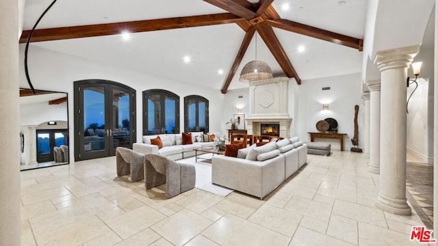 living room featuring ornate columns, beam ceiling, french doors, and high vaulted ceiling