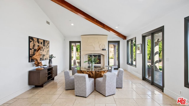 living room featuring lofted ceiling with beams and a high end fireplace