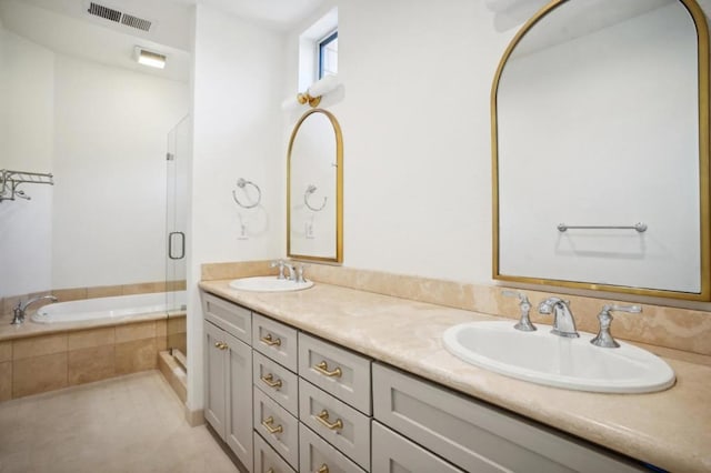 bathroom with vanity and shower with separate bathtub