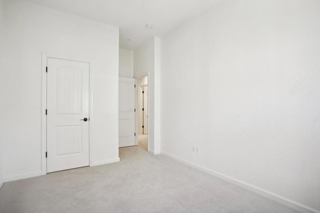 unfurnished bedroom featuring light colored carpet