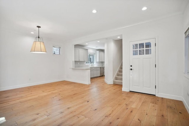 entrance foyer with sink and light hardwood / wood-style flooring