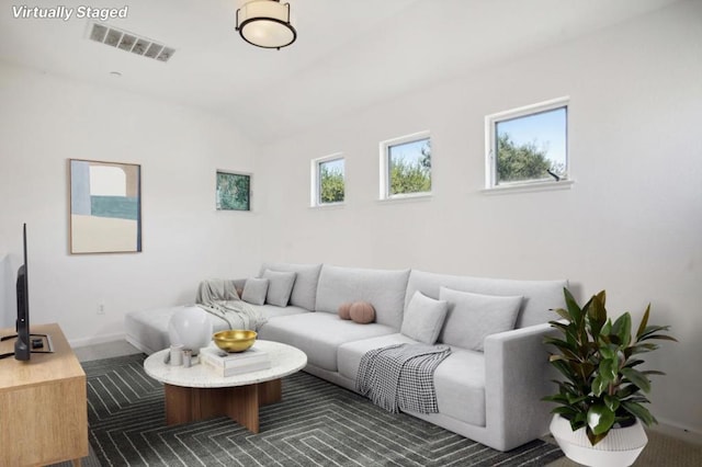 living room with lofted ceiling and carpet flooring