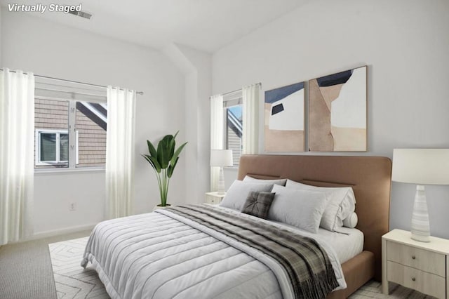 bedroom featuring light colored carpet