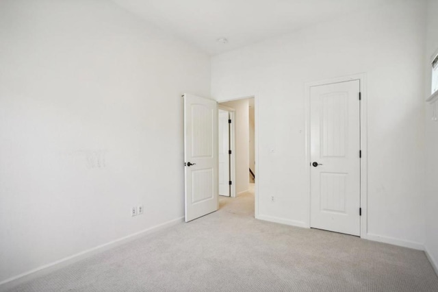 unfurnished bedroom featuring light carpet