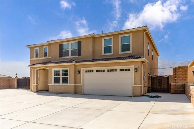 21047 Iron Rail Dr, Riverside, CA 92507 - traditional-style home with a garage, fence, stucco siding, a gate, and driveway