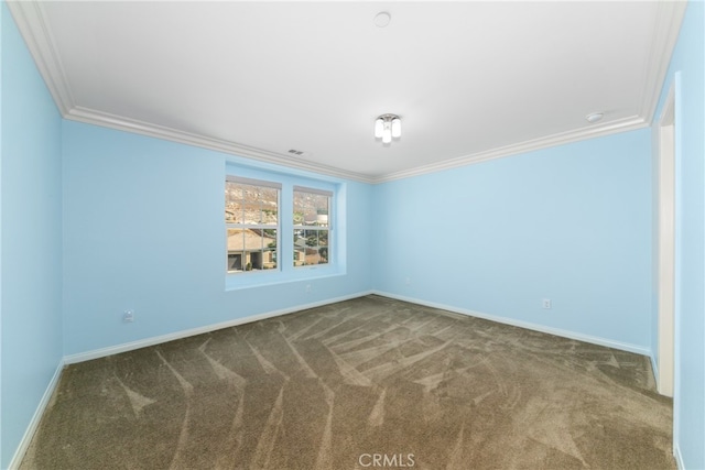 carpeted empty room featuring crown molding