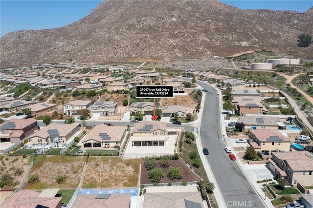 birds eye view of property featuring a mountain view