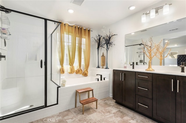 bathroom featuring vanity and shower with separate bathtub