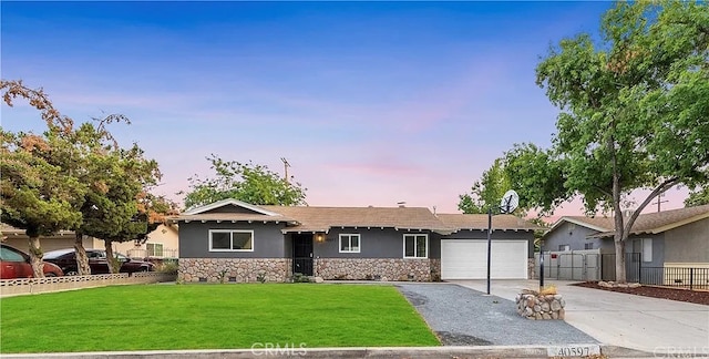 ranch-style home with a yard and a garage