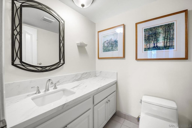 bathroom featuring tile patterned floors, vanity, and toilet