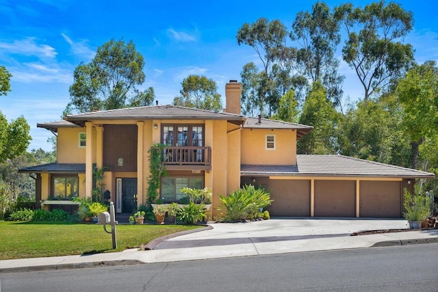 view of front of property with a garage and a front lawn