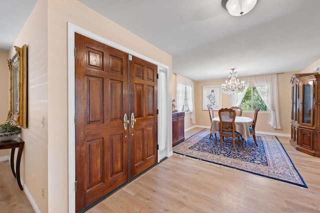 dining area with a chandelier and light hardwood / wood-style flooring