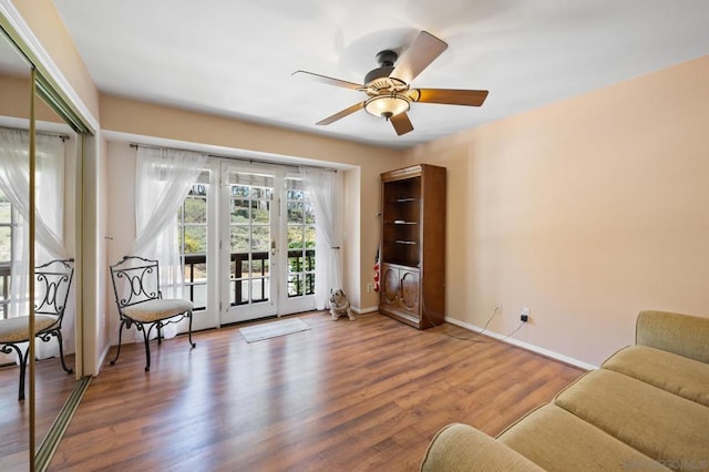 living area with hardwood / wood-style flooring and ceiling fan