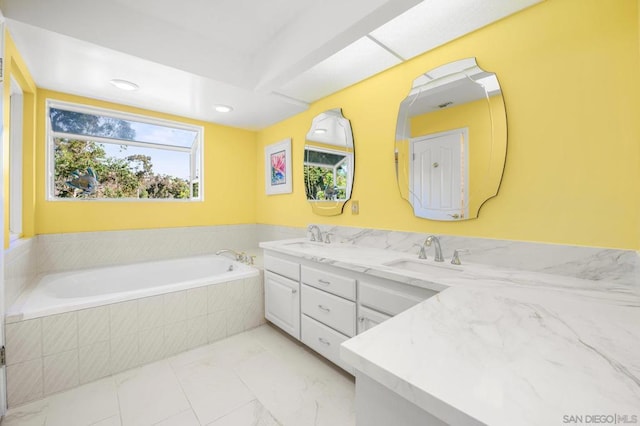 bathroom with vanity and a relaxing tiled tub