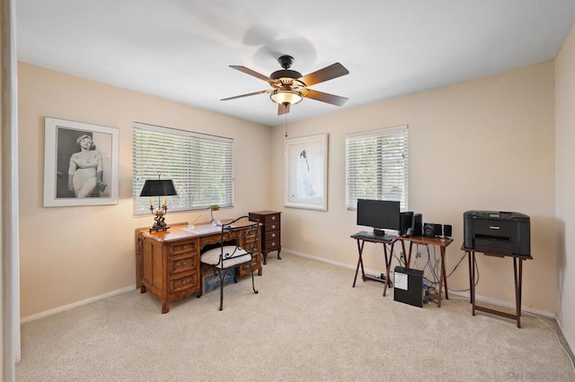 carpeted office space with ceiling fan