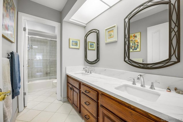 full bathroom featuring tile patterned flooring, vanity, toilet, and bath / shower combo with glass door