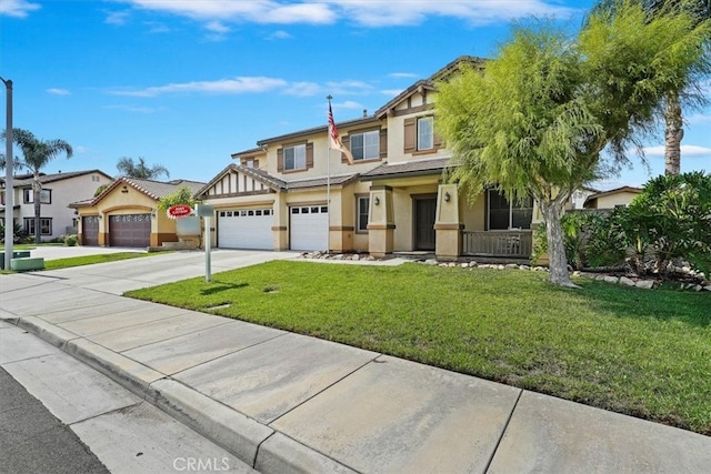 view of front of property featuring covered porch, a front yard, and a garage