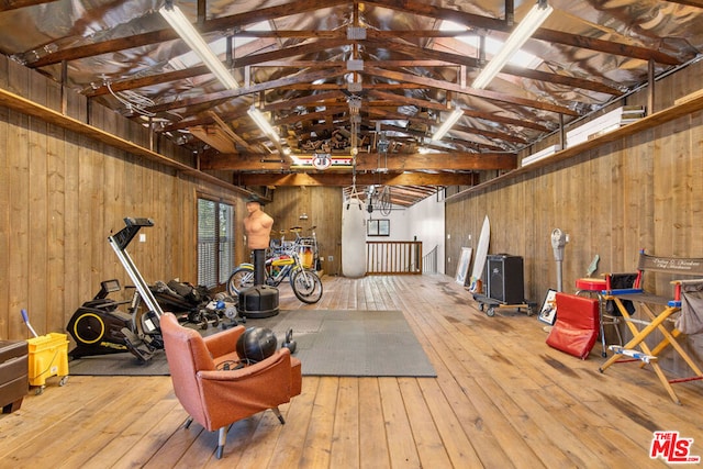 miscellaneous room featuring wood-type flooring, vaulted ceiling with beams, and wood walls