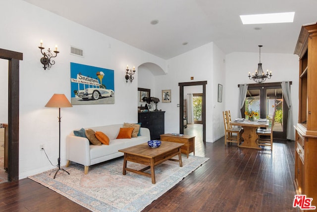 living room featuring dark hardwood / wood-style flooring, high vaulted ceiling, and an inviting chandelier