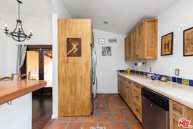 kitchen with appliances with stainless steel finishes, vaulted ceiling, dark wood-type flooring, pendant lighting, and a notable chandelier