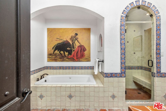 bathroom featuring tiled tub