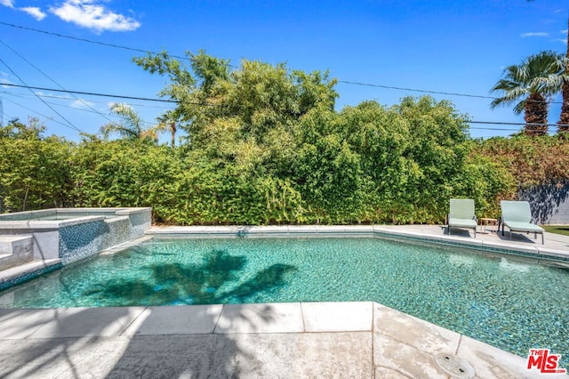 view of pool with an in ground hot tub and a patio area