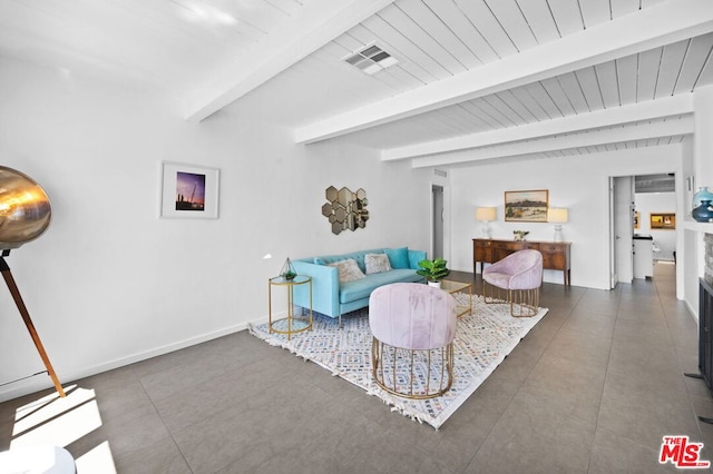 living room with beam ceiling and dark tile patterned floors