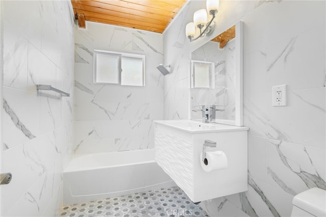 full bathroom with tiled shower / bath, vanity, wood ceiling, and toilet