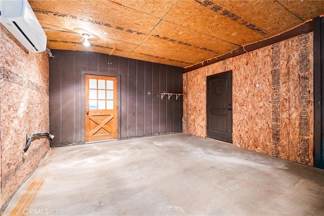 misc room with concrete floors and an AC wall unit