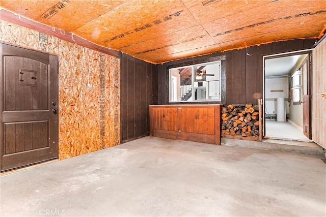 interior space with wooden walls and concrete floors