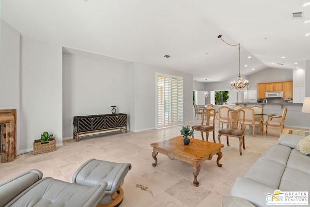 living room with lofted ceiling and an inviting chandelier