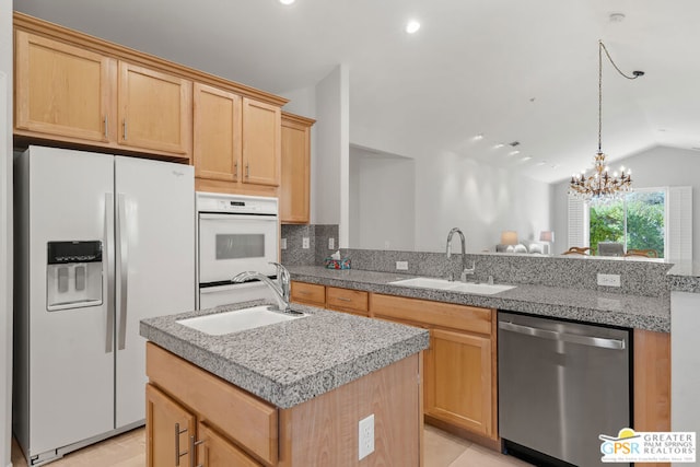 kitchen featuring stainless steel dishwasher, white fridge with ice dispenser, sink, and vaulted ceiling