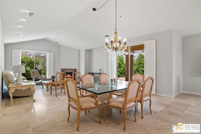 dining space with a notable chandelier and lofted ceiling