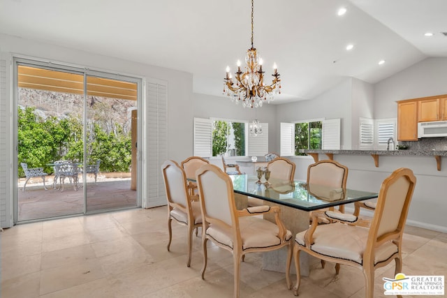 dining space featuring an inviting chandelier, sink, vaulted ceiling, and light tile patterned flooring