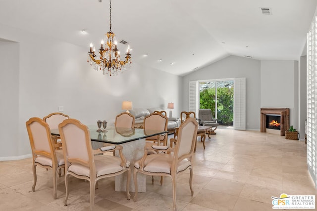 dining area featuring lofted ceiling and a chandelier