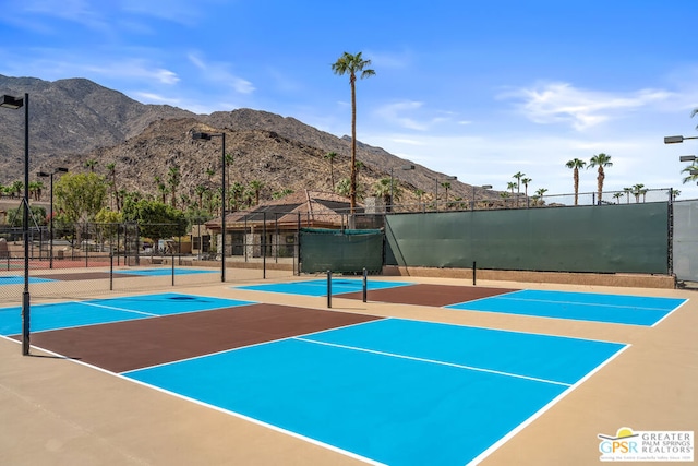 surrounding community with tennis court and a mountain view