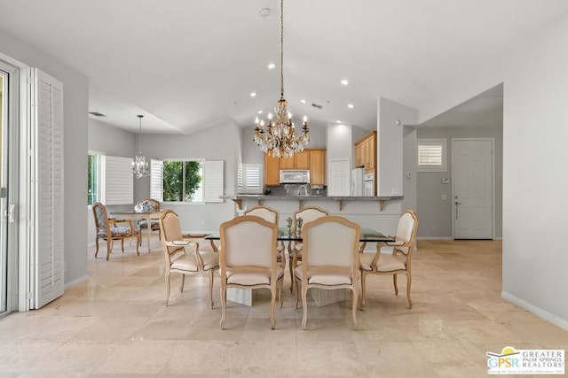 dining area featuring vaulted ceiling and a chandelier