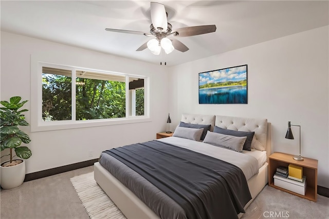 bedroom with ceiling fan and light colored carpet